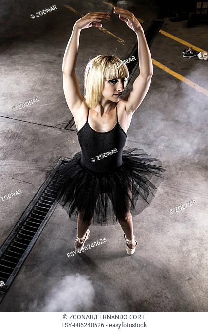 Posing, ballet dancer in an industry area, sensual blonde woman with tutu