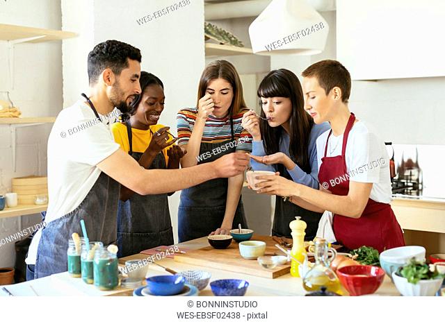 Friends tasting food in a cooking workshop