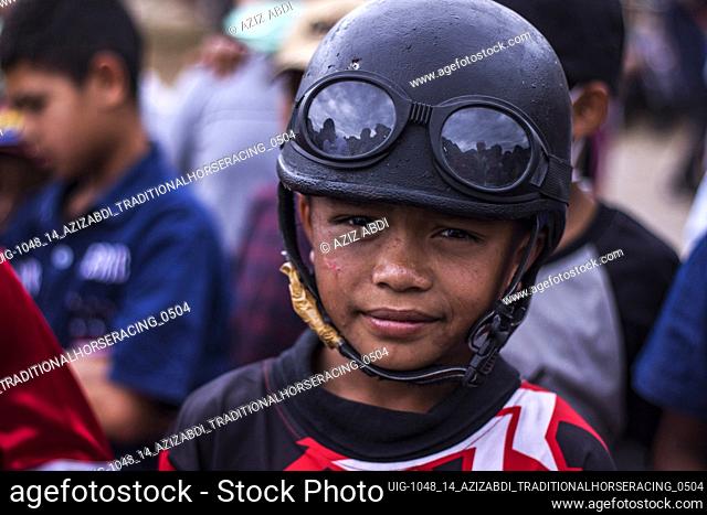 Rizkan Abadi is still 13 years old, the little jockey who has gained many champions in the race, gets ready to race horses at HM Hasan Field, Blang Bebangka