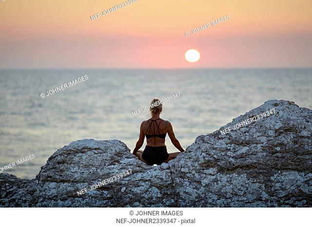 Woman meditating at sea