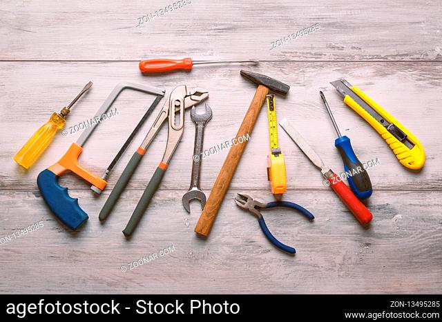 Screwdriver, hammer, tape measure and other tool for construction tools on gray wooden background with copy space, industry engineer tool concept