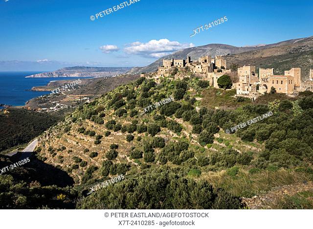 The stone tower houses of the village of Vathia and the dramatic coast of the Deep Mani in the background, Southern peloponnese, Greece