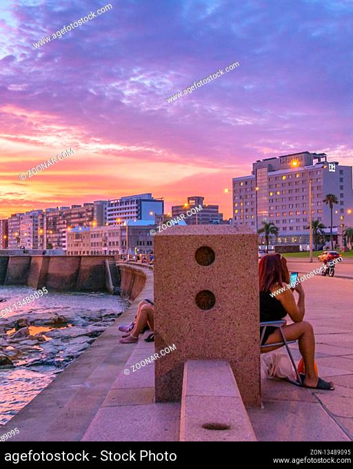 MONTEVIDEO, URUGUAY, JANUARY - 2018 - Beautiful urban coastal sunset scene at rambla sur, one of the boardwalks of montevideo city, uruguay