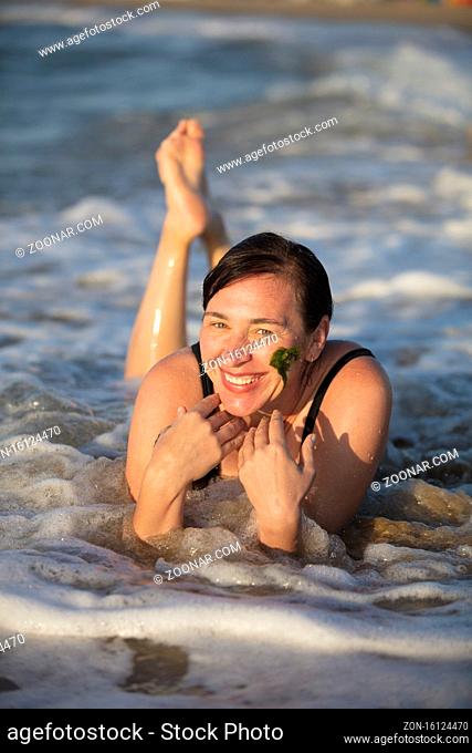 Elderly woman at the sea. Man at rest in the waves.Portrait of a senior woman bathing in the sea