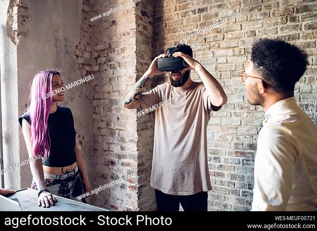 Creative team using Vr goggles in loft office