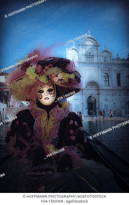 A mystical view of a masked woman in a gondola at the carnival in Venice, Italy, Europe