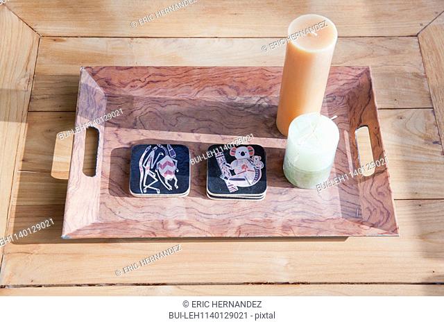 Close-up of candles with tray on wooden table in sunlight; Dana Point; California; USA