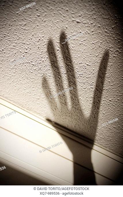 Shadow of hand on wall