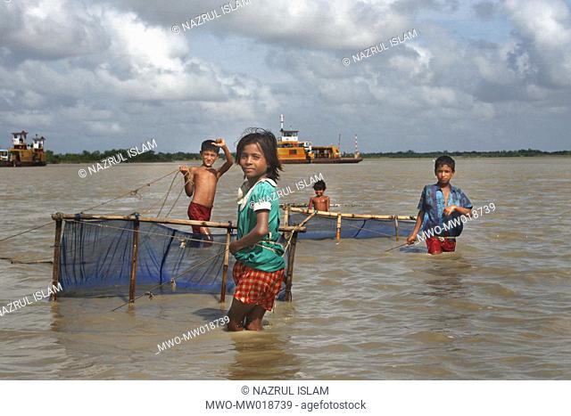 Children catching prawns on the bank of the river Andharmanik, Kalapara, Patuakhali The village was hit badly during Cyclone SIDR in November