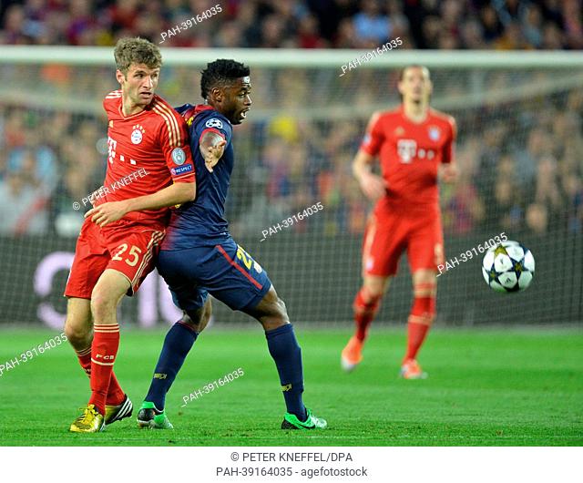 Barcelona's Alex Song (C) and Munich's Thomas Mueller (L) vie for the ball during the UEFA Champions League semi final second leg soccer match between FC...