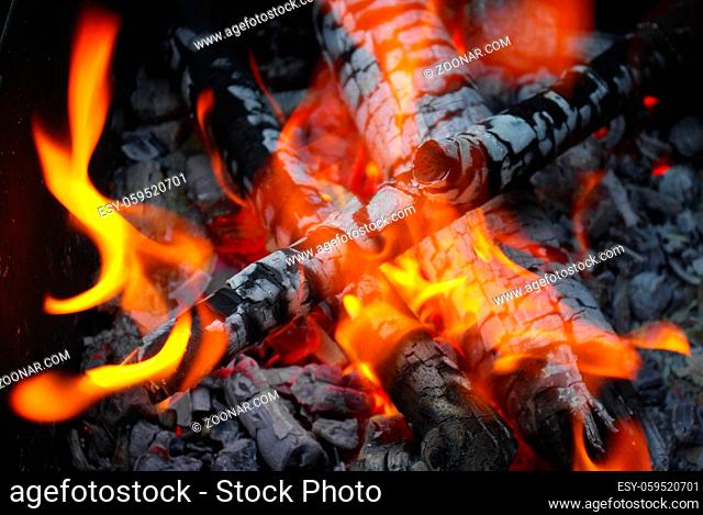 Fire and coals. Bright flame in the bonfire. Selective focus