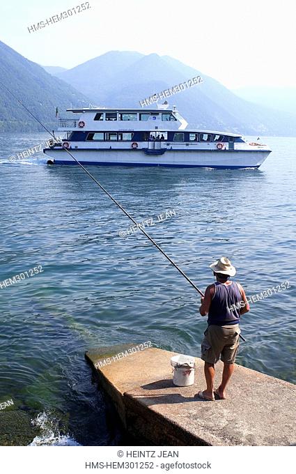 Italy, Lombardy, Como, fisherman at the edge of the lake