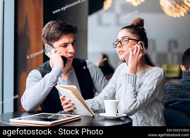 Guy and girl at a business meeting in a cafe