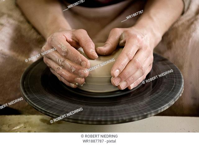 Craftswoman working on pottery wheel, Bavaria, Germany, Europe