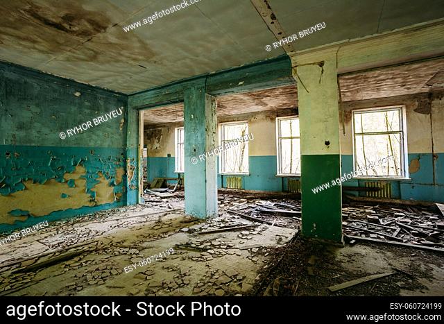 The Ruined Hall Of Abandoned Rural School After Chernobyl Disaster In Evacuation Zone. The Terrible Consequences Of The Nuclear Pollution Twenty Years Later