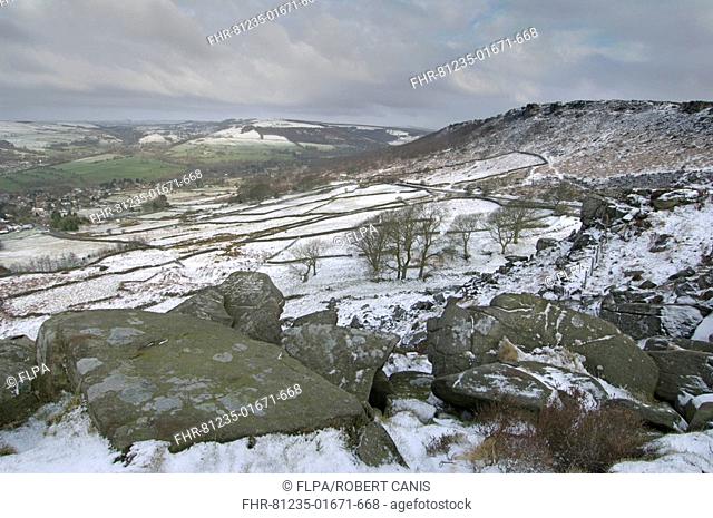 View of upland rock escarpments in snow, Baslow and Curbar Edge, Peak District, Derbyshire, England, march