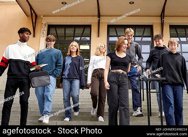 Teenagers in front of school