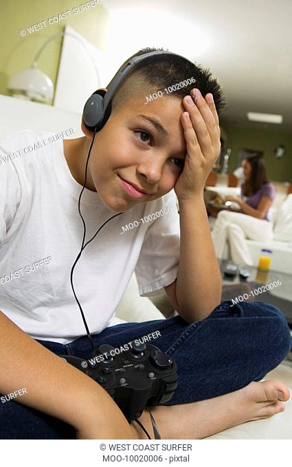 Frustrated Boy with Headphones Playing Video Game