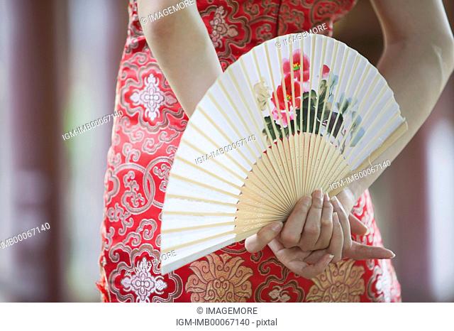Close-up of human hands holding a fan