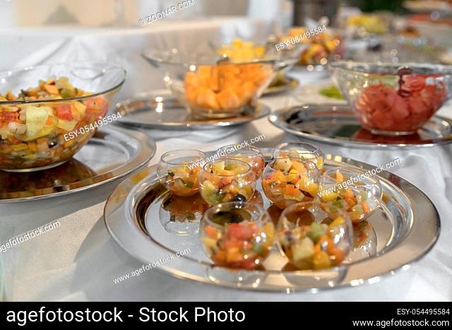 Beautifully decorated catering banquet table with different food fresh fruits for parties, events or wedding celebration, served on silver plate