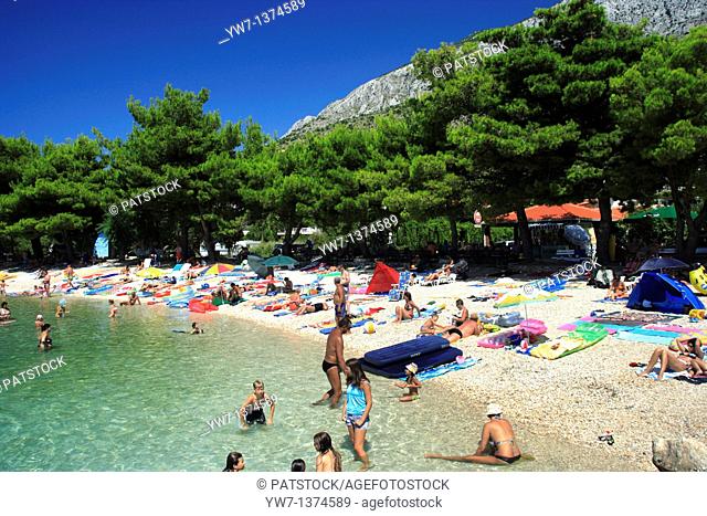 Tourists enjoying their time at a beach in Zivogosce village, Croatia