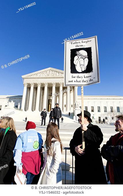 Pro-Life supporters hold up signs in front of the Supreme Court
