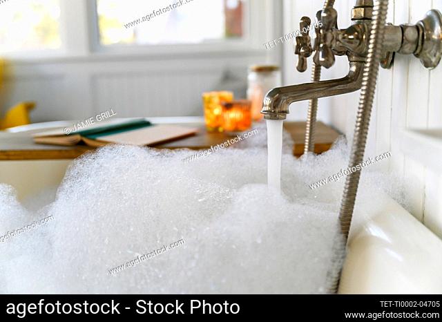 Bubble bath with book and candles