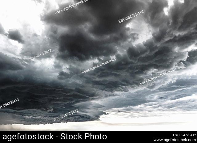 Supercell thunderstorm. Dramatic black clouds and motion. Dark sky with thunderstorm before rainy