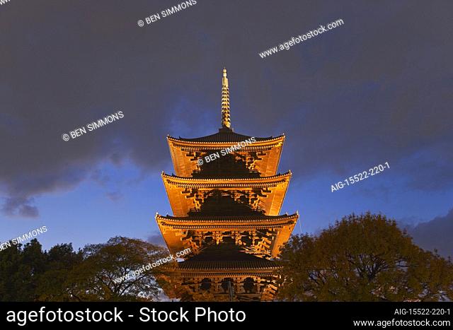 Toji Temple's wooden five-storied pagoda (the tallest wooden tower in Japan) is illuminated at twilight in the center of Kyoto, Japan