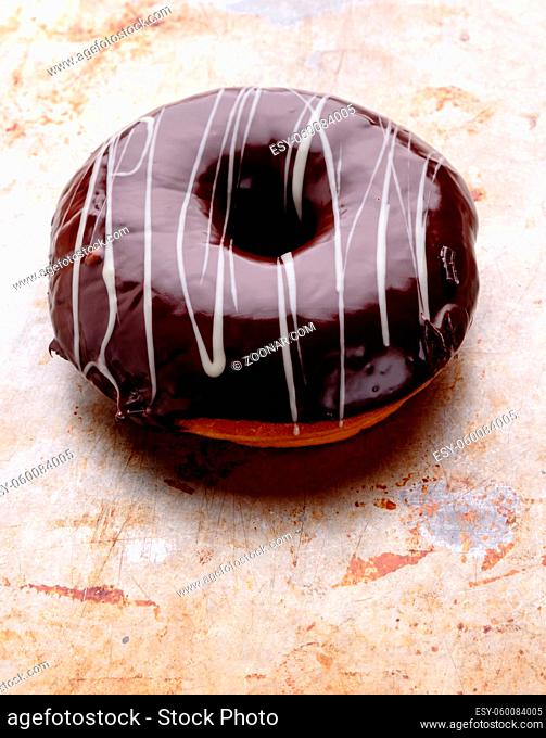 sweet delicious chocolate donut on steel plate