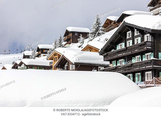 Snow and wooden houses in the alpine village and sky resort Bettmeralp district of Raron canton of Valais Switzerland Europe