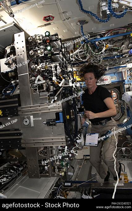 NASA astronaut and Expedition 65 Flight Engineer Megan McArthur replaces components inside the Combustion Integrated Rack