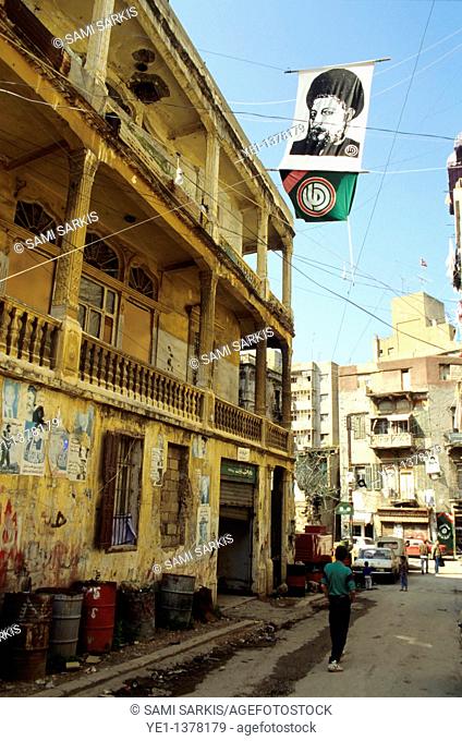Man walking down a street with derelict buildings, Minet El Hosn, Beirut, Lebanon