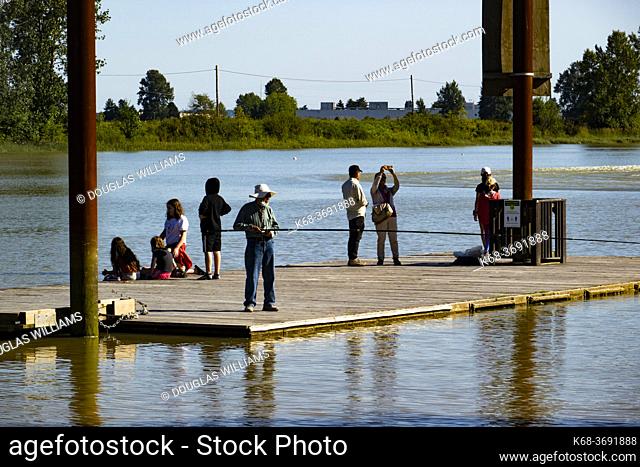 People on a dock at Deas Island in the Fraser River, Ladner, BC, Canada