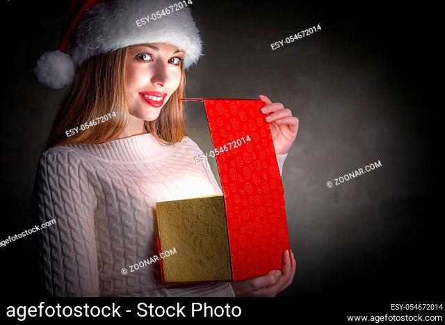 Christmas Gift.Holidays magic. Happy Girl Opening a Gift Box