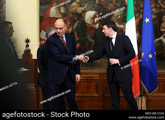 Italian politician Enrico Letta gives the bell to the new prime minister Matteo Renzi on the occasion of the bell ceremony at Palazzo Chigi