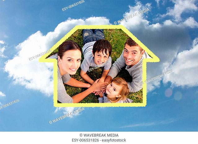 Composite image of young parents and kid lying on garden with hands together