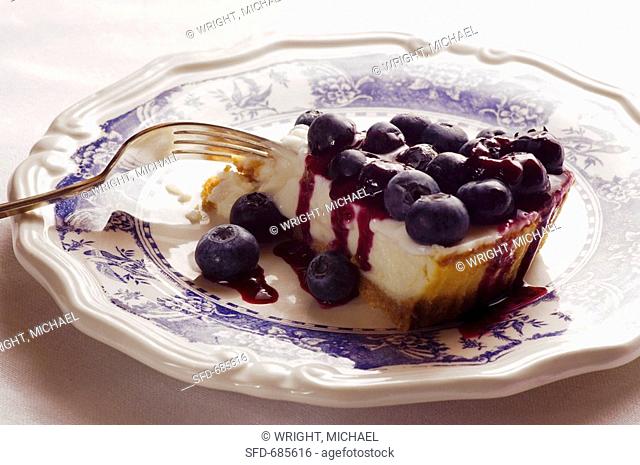Slice of New York Cheesecake with Blueberry Topping, Fork