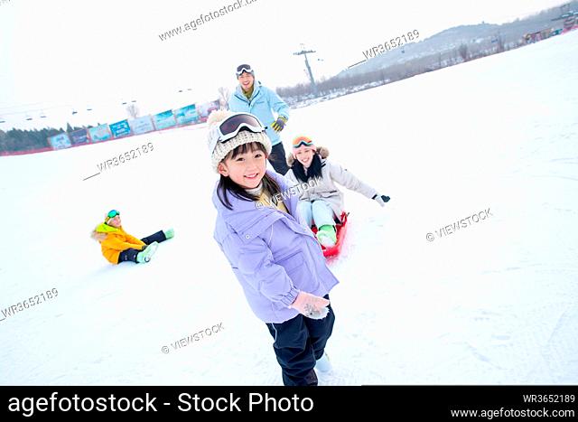 A family of four ski resorts play the snow on the board