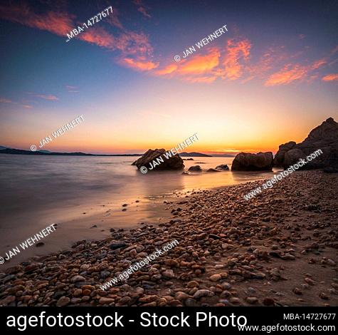 Sunset on the sandy beach of the village Ouranoupoli near Thessaloniki, Greece