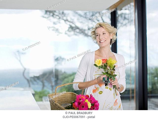 Woman carrying basket of flowers