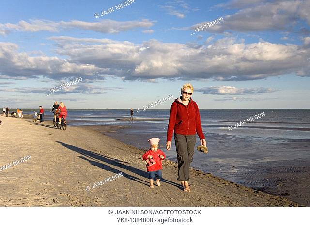 Woman with Kid in Red Clothes Walking Hand in Hand on Pärnu Beach in Estonia, Europe