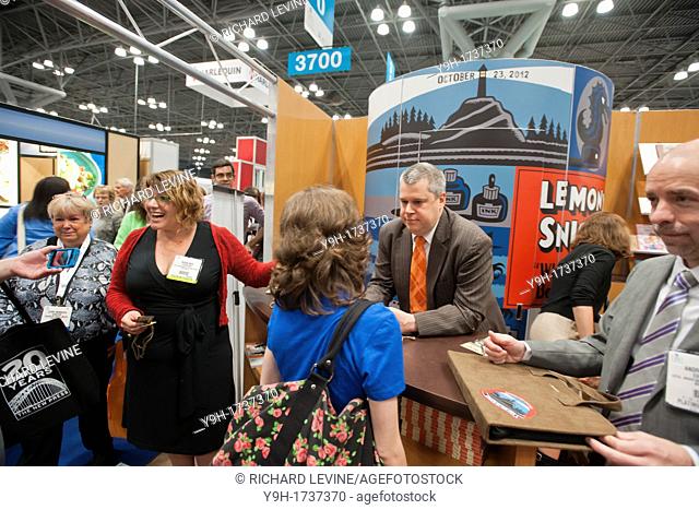 Daniel Handler, known under the pen name of Lemony Snicket, signs at the Little, Brown booth at the huge Book Expo America at the Jacob Javits Convention Center...