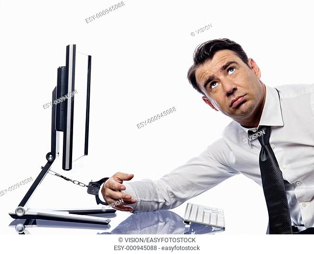 caucasian man chained to computer with handcuffs expressing addiction concept isolated studio on white background