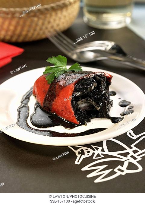 Red peppers stuffed with squid cooked in their ink