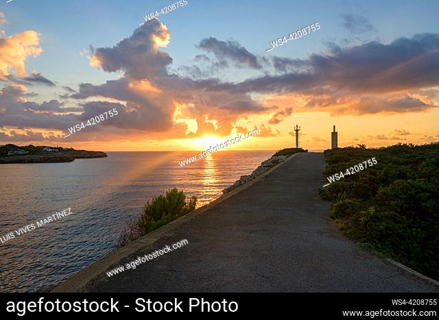 sunrise on the mediterranean coast, on the way to the lighthouse by the cliffs,