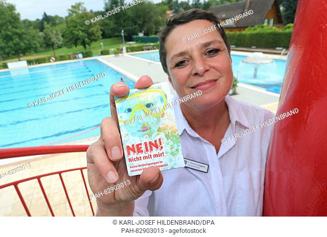Veronika Waescher-Goeggerle, delegate for women and families of the city of Tettnant, holding up a folder of the Campaign 'NEIN! Nicht mit mir!' (lit