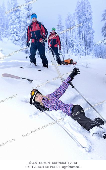 Ski patrol rescue injured woman after accident lying in snow