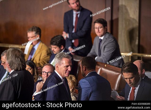 Former Speaker of the United States House of Representatives Kevin McCarthy (Republican of California) chats with his fellow members during the third attempt...