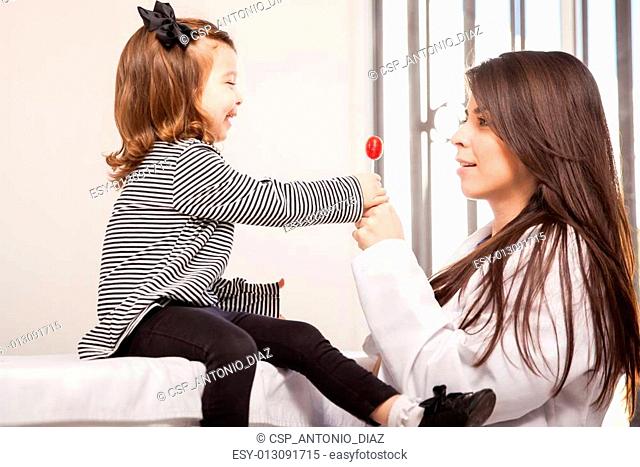 Little girl getting a lollipop